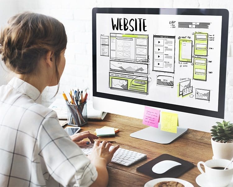 a girl on her working desk looking at a graphic monitor screen